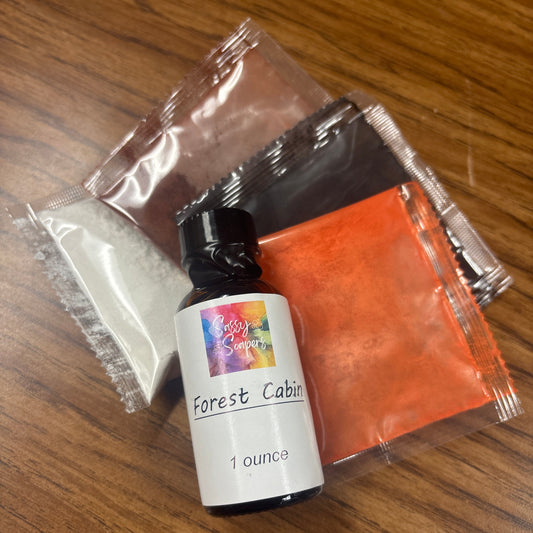 Small bottle labeled 'Forest Cabin' fragrence oils  with a colorful label on a wooden surface