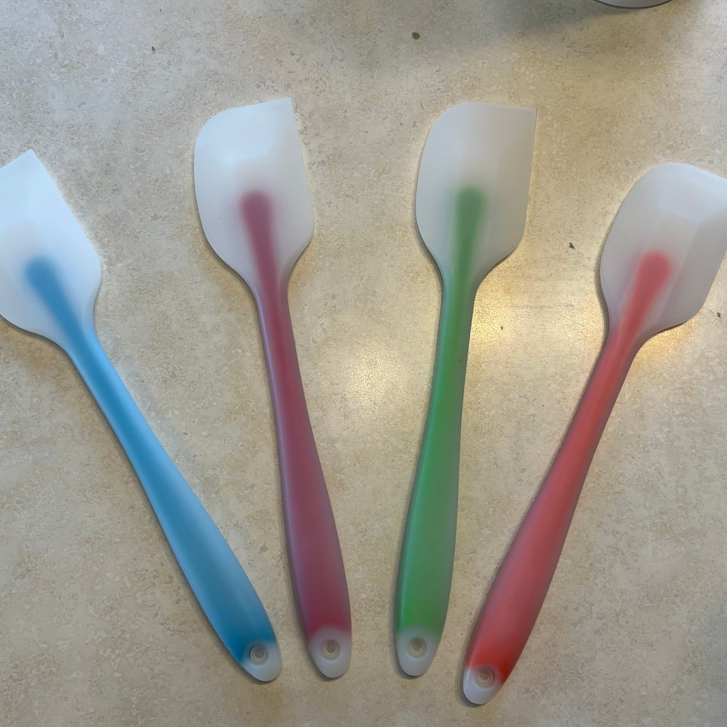 blue, red, green, orange rubber spatulas with white tips 